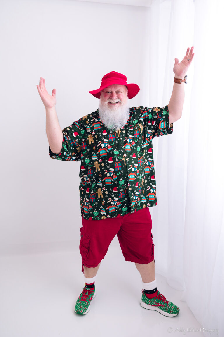 Santa Vacation Mode wearing red shorts and a Christmas Themed Hawaiian Shirt